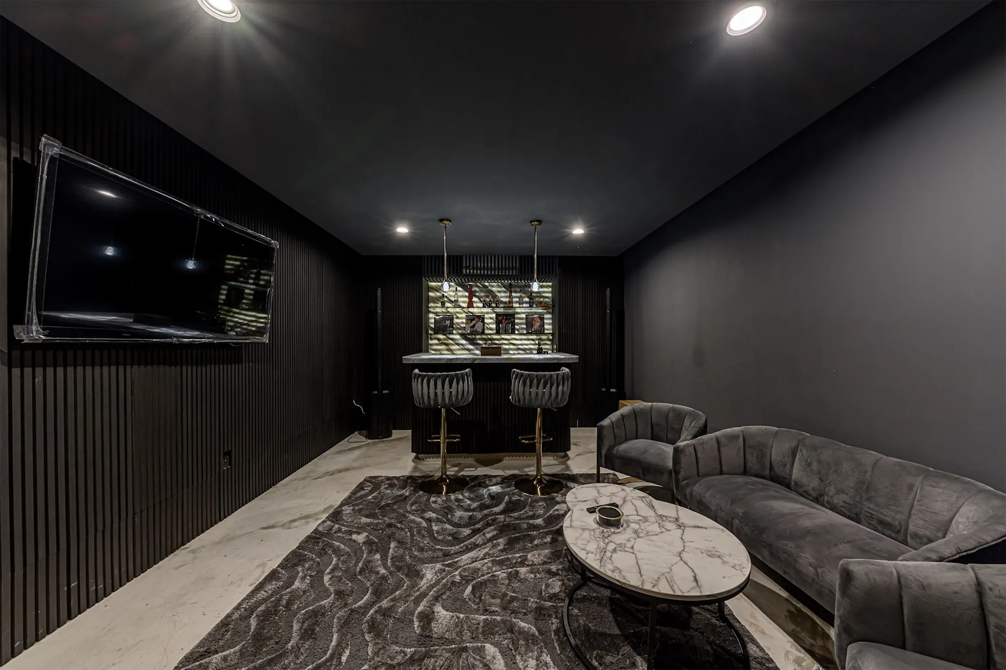 A second room as it is today, a dark media lounge and bar.