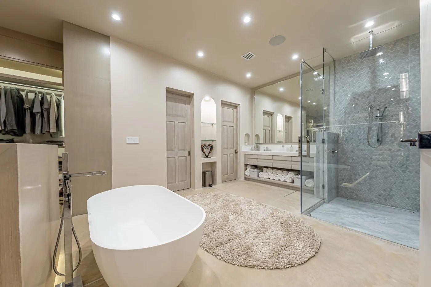 Master bathroom with freestanding tub, marble walk-in shower and an adjoining dressing room.